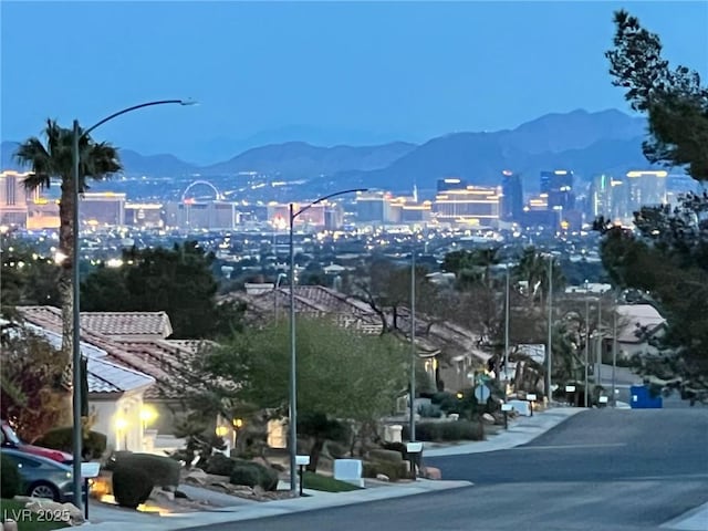2736 Darby Falls Dr, Las Vegas, NV 89134 - view of asphalt street featuring a mountain view, street lighting, and a city view