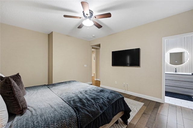bedroom featuring baseboards, wood finished floors, and a ceiling fan