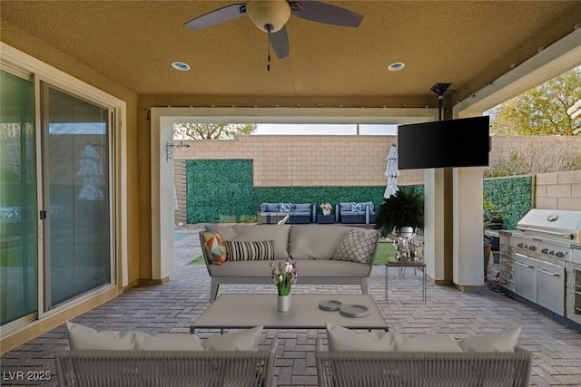 view of patio with fence, area for grilling, grilling area, a ceiling fan, and outdoor lounge area