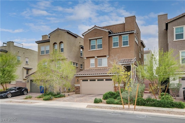 105 Campbelltown Ave, Henderson, NV 89015 - view of front of property with a tiled roof, stucco siding, an attached garage, and driveway