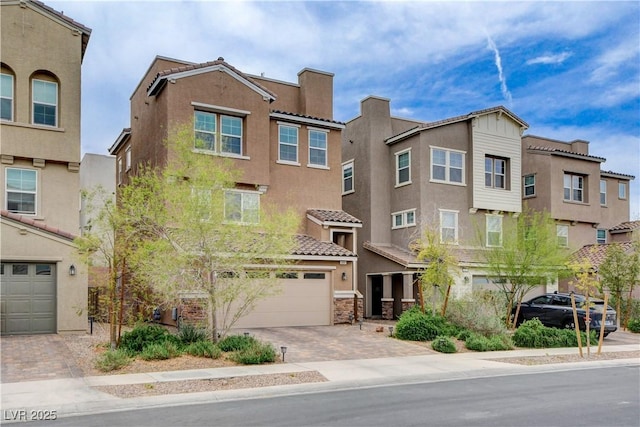 105 Campbelltown Ave, Henderson, NV 89015 - townhome / multi-family property featuring driveway, an attached garage, a tiled roof, and stucco siding