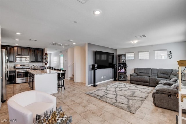 105 Campbelltown Ave, Henderson, NV 89015 - living area with light tile patterned floors, recessed lighting, a healthy amount of sunlight, and visible vents