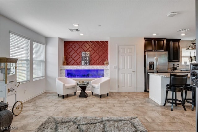 105 Campbelltown Ave, Henderson, NV 89015 - dining room with recessed lighting, a glass covered fireplace, an accent wall, and visible vents