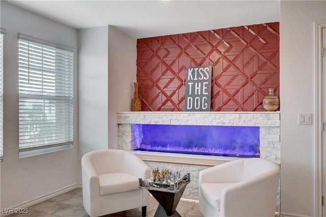 105 Campbelltown Ave, Henderson, NV 89015 - interior space featuring baseboards, a glass covered fireplace, an accent wall, and tile patterned floors