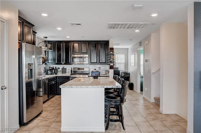 105 Campbelltown Ave, Henderson, NV 89015 - kitchen with a kitchen island, light tile patterned flooring, stainless steel appliances, and visible vents