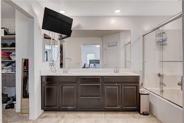 105 Campbelltown Ave, Henderson, NV 89015 - bathroom featuring combined bath / shower with glass door, double vanity, a spacious closet, and a sink