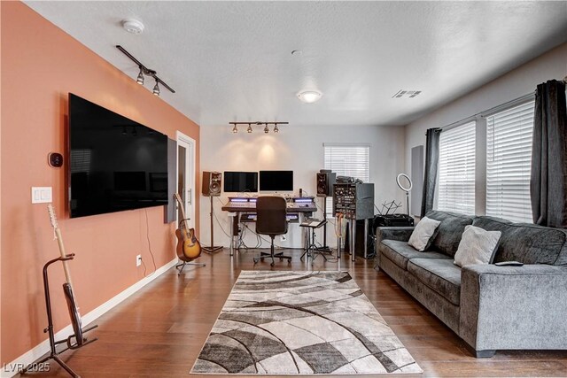 105 Campbelltown Ave, Henderson, NV 89015 - living area featuring baseboards, rail lighting, visible vents, and wood finished floors