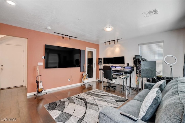 105 Campbelltown Ave, Henderson, NV 89015 - living room featuring baseboards, rail lighting, visible vents, and wood finished floors