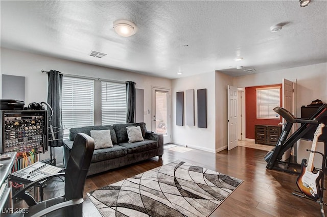 105 Campbelltown Ave, Henderson, NV 89015 - living room featuring a textured ceiling, visible vents, wood finished floors, and a healthy amount of sunlight