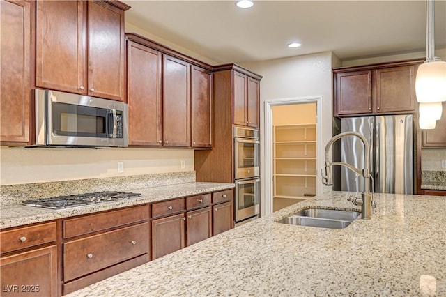 1004 Bluebird Ridge Ct, North Las Vegas, NV 89084 - kitchen featuring appliances with stainless steel finishes, recessed lighting, light stone counters, and pendant lighting