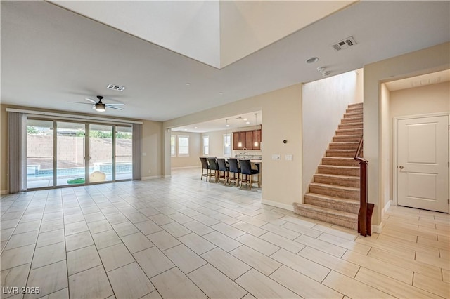 1004 Bluebird Ridge Ct, North Las Vegas, NV 89084 - living room featuring a ceiling fan, stairs, and light tile patterned flooring