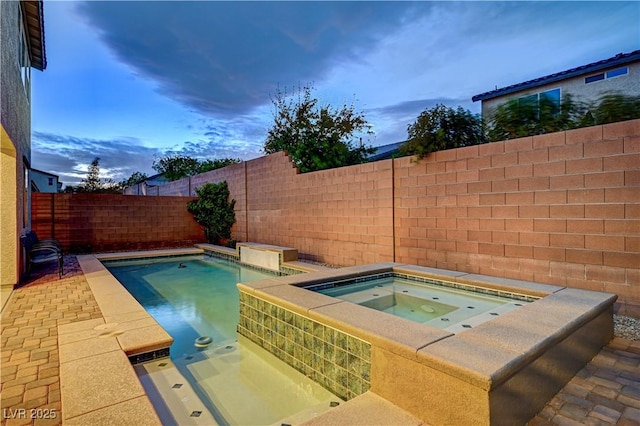 1004 Bluebird Ridge Ct, North Las Vegas, NV 89084 - pool at dusk featuring an in-ground hot tub and a fenced backyard