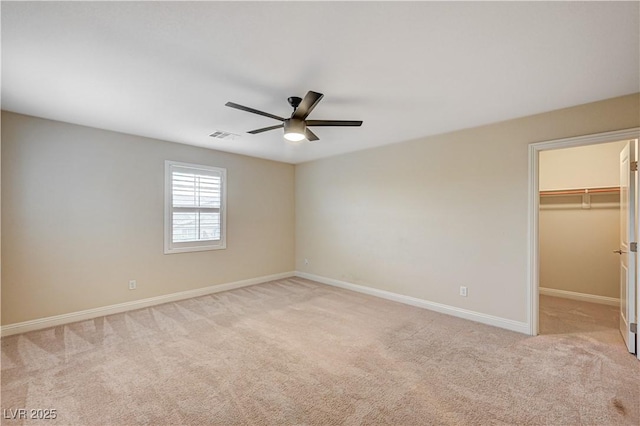 1004 Bluebird Ridge Ct, North Las Vegas, NV 89084 - unfurnished bedroom featuring light carpet, a spacious closet, ceiling fan, and a closet