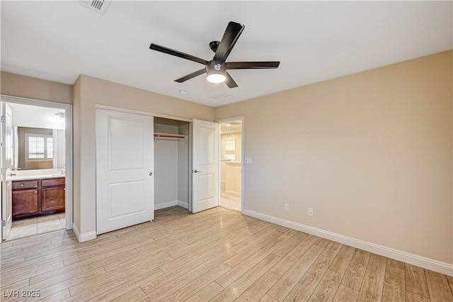 1004 Bluebird Ridge Ct, North Las Vegas, NV 89084 - unfurnished bedroom with light wood-style floors, a closet, connected bathroom, and ceiling fan