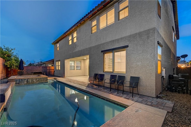 1004 Bluebird Ridge Ct, North Las Vegas, NV 89084 - back of house featuring stucco siding, a fenced backyard, a patio, and a pool with connected hot tub