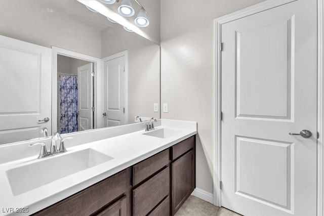 505 Punto Vallata Dr, Henderson, NV 89011 - bathroom with double vanity, tile patterned flooring, a sink, and baseboards