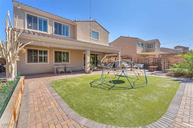 505 Punto Vallata Dr, Henderson, NV 89011 - rear view of house with stucco siding, a patio, a fenced backyard, a tiled roof, and a lawn