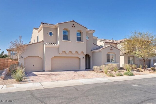 505 Punto Vallata Dr, Henderson, NV 89011 - mediterranean / spanish-style house with stucco siding, a tile roof, and decorative driveway