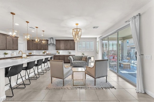 505 Punto Vallata Dr, Henderson, NV 89011 - living area featuring light tile patterned flooring, baseboards, visible vents, and a chandelier