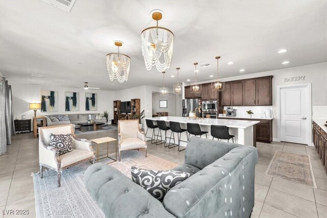 505 Punto Vallata Dr, Henderson, NV 89011 - living area featuring light tile patterned flooring, ceiling fan with notable chandelier, visible vents, and recessed lighting
