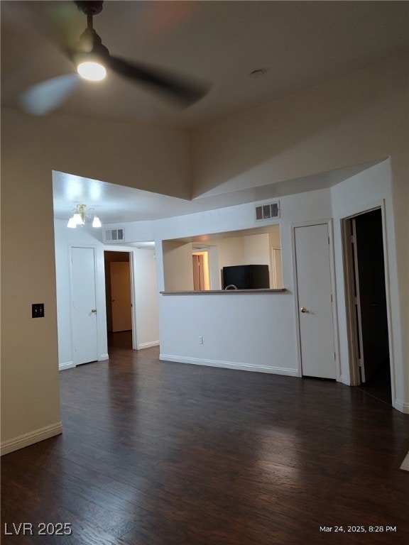 unfurnished living room featuring dark wood-style flooring, baseboards, a ceiling fan, and visible vents