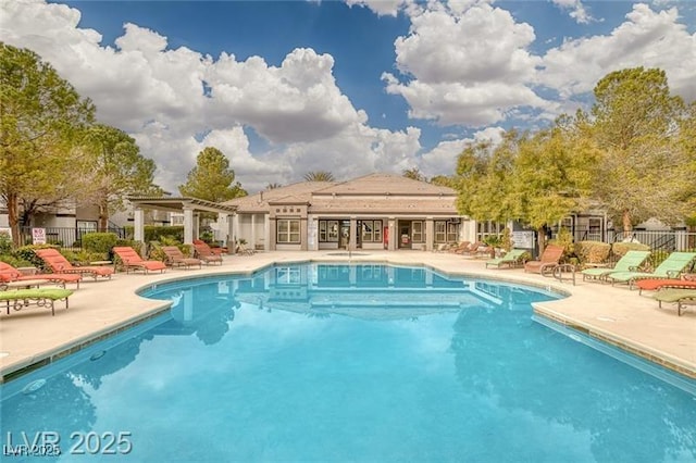 community pool featuring a pergola, a patio, and fence