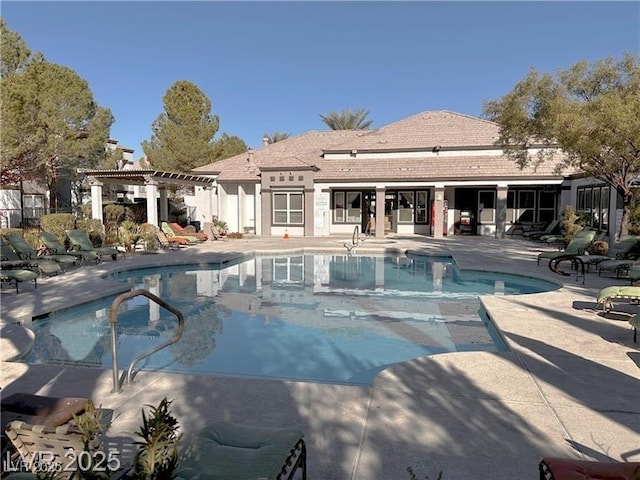 pool featuring a patio and a pergola