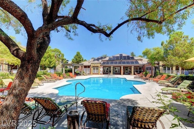 pool featuring fence and a patio
