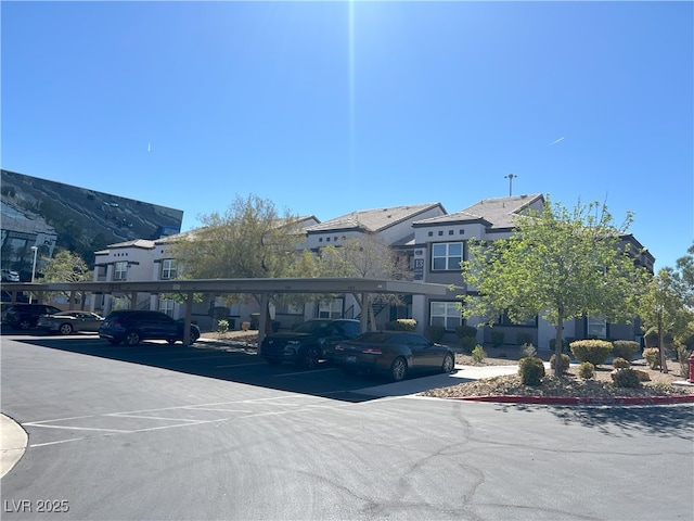 exterior space featuring covered parking and stucco siding