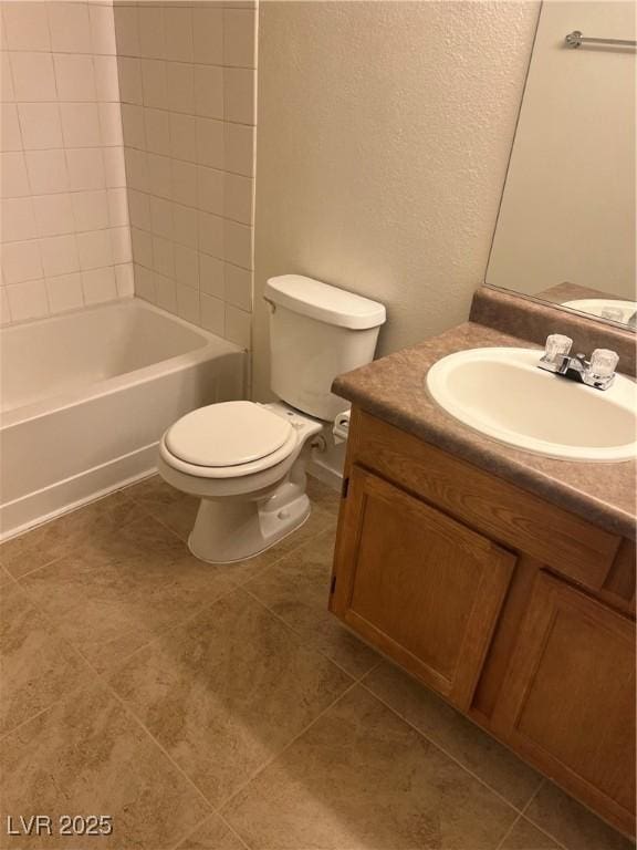 full bathroom featuring toilet, tile patterned floors, vanity, and washtub / shower combination