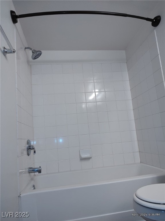 bathroom with toilet and bathing tub / shower combination
