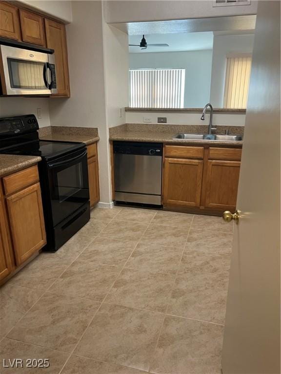 kitchen featuring a sink, brown cabinets, and stainless steel appliances