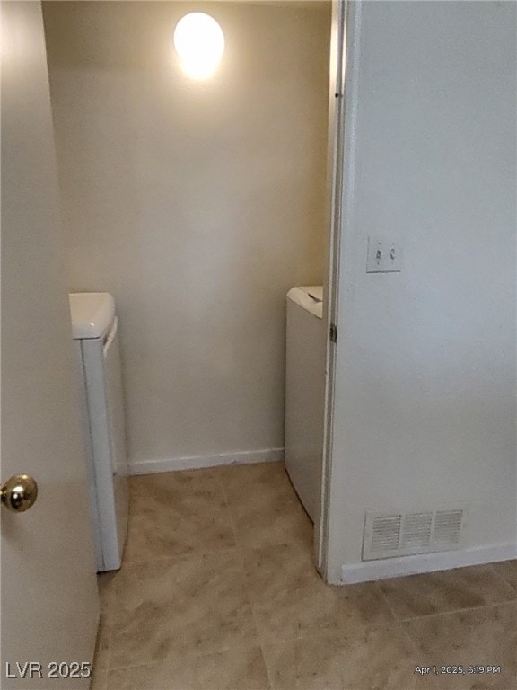 bathroom featuring washer / clothes dryer, visible vents, and toilet