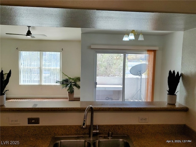 kitchen featuring a sink and a ceiling fan
