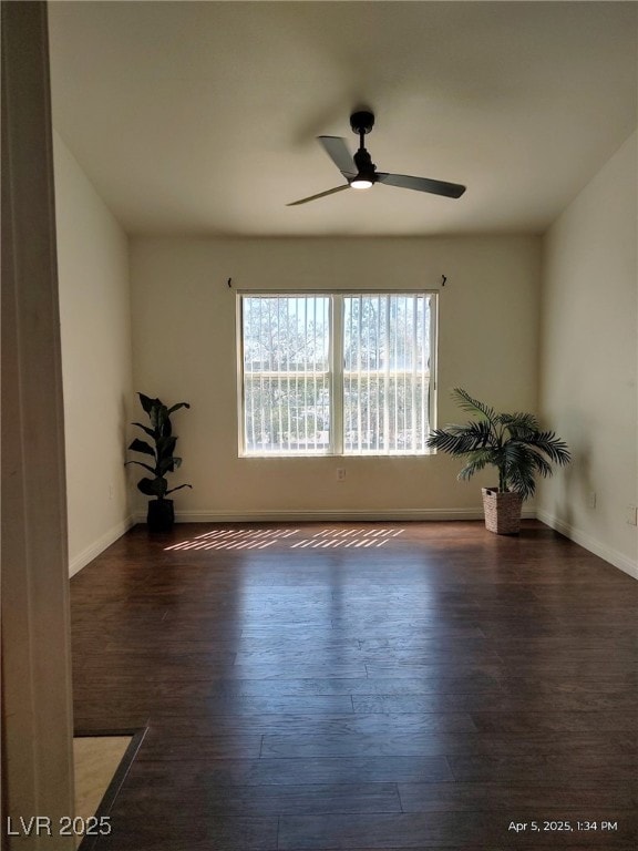 empty room with baseboards, a ceiling fan, and wood finished floors