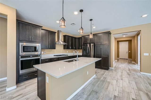 243 Sun Glaze Ave, Henderson, NV 89011 - kitchen featuring appliances with stainless steel finishes, wall chimney exhaust hood, a sink, baseboards, and light wood-style flooring
