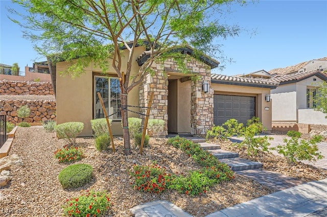 243 Sun Glaze Ave, Henderson, NV 89011 - view of front of house with a garage, stucco siding, stone siding, and fence