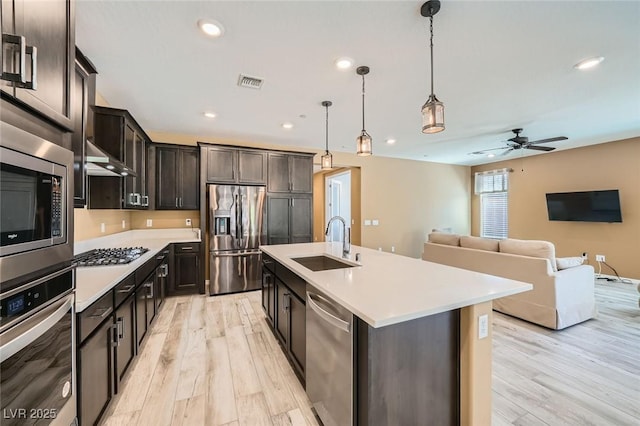 243 Sun Glaze Ave, Henderson, NV 89011 - kitchen featuring appliances with stainless steel finishes, a sink, light wood-style floors, light countertops, and ceiling fan