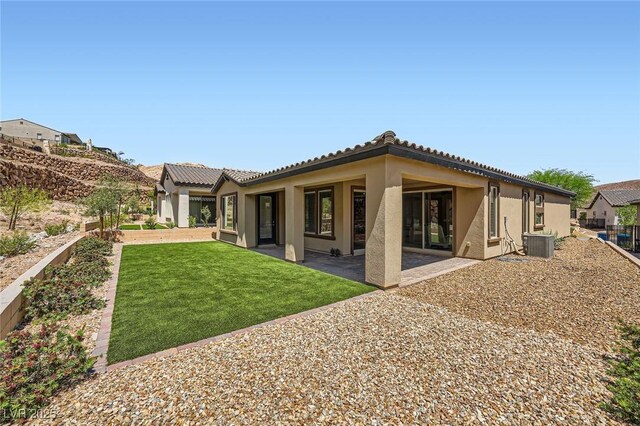 243 Sun Glaze Ave, Henderson, NV 89011 - back of house featuring stucco siding, a yard, a patio area, cooling unit, and a tile roof
