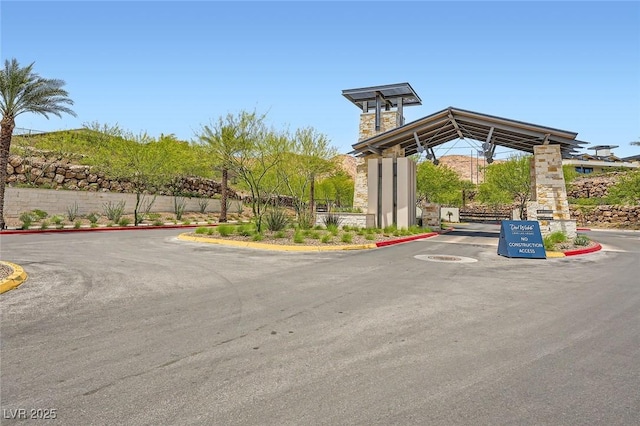 243 Sun Glaze Ave, Henderson, NV 89011 - view of asphalt road with curbs and a gated entry