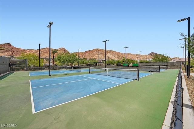 243 Sun Glaze Ave, Henderson, NV 89011 - view of tennis court with a mountain view and fence