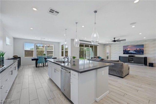 1609 Dream Canyon Ave, North Las Vegas, NV 89084 - kitchen featuring dark countertops, dishwasher, visible vents, a sink, and light wood-style floors