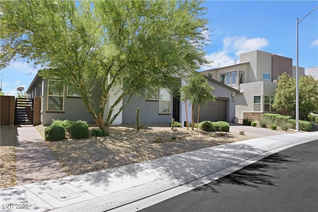 1609 Dream Canyon Ave, North Las Vegas, NV 89084 - view of front of home featuring stucco siding, an attached garage, fence, and concrete driveway