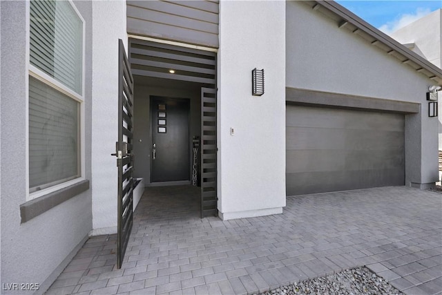 1609 Dream Canyon Ave, North Las Vegas, NV 89084 - doorway to property featuring a garage and stucco siding