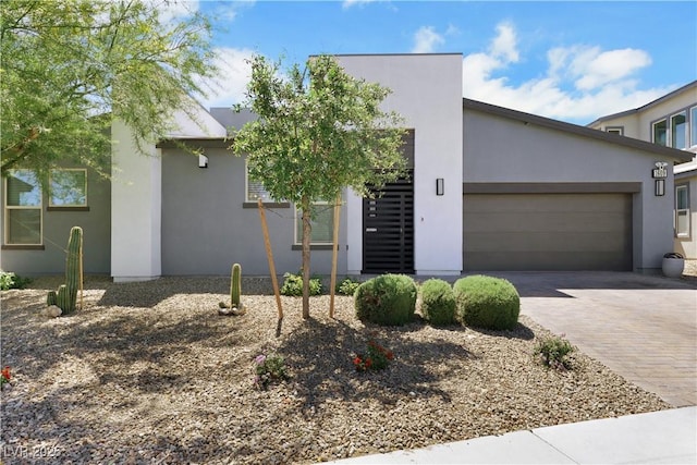 1609 Dream Canyon Ave, North Las Vegas, NV 89084 - view of front facade with an attached garage, decorative driveway, and stucco siding