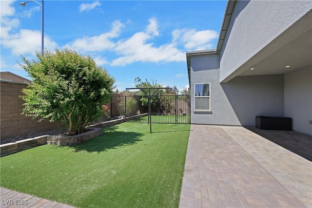 1609 Dream Canyon Ave, North Las Vegas, NV 89084 - view of yard featuring a fenced backyard and a patio