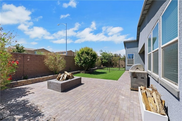 1609 Dream Canyon Ave, North Las Vegas, NV 89084 - view of patio / terrace featuring a fenced backyard and an outdoor fire pit