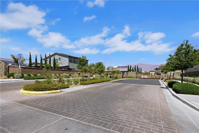 1609 Dream Canyon Ave, North Las Vegas, NV 89084 - view of street featuring a gated entry, curbs, a mountain view, and a residential view