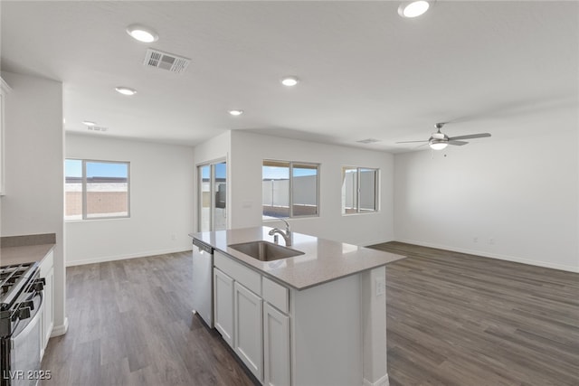 kitchen featuring a sink, white cabinetry, appliances with stainless steel finishes, open floor plan, and ceiling fan