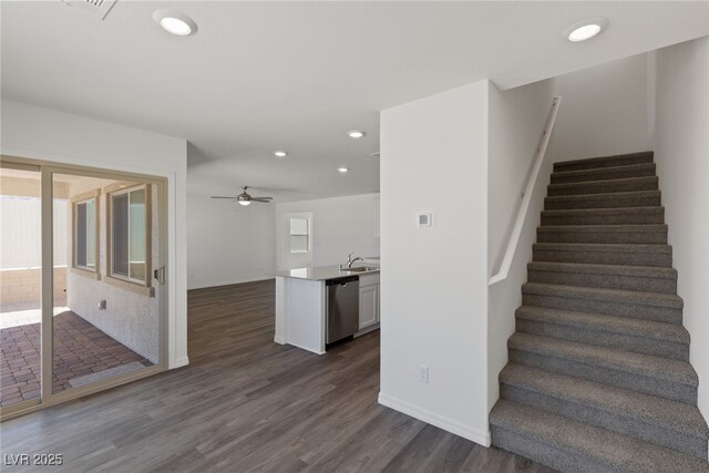 stairs with baseboards, ceiling fan, wood finished floors, and recessed lighting